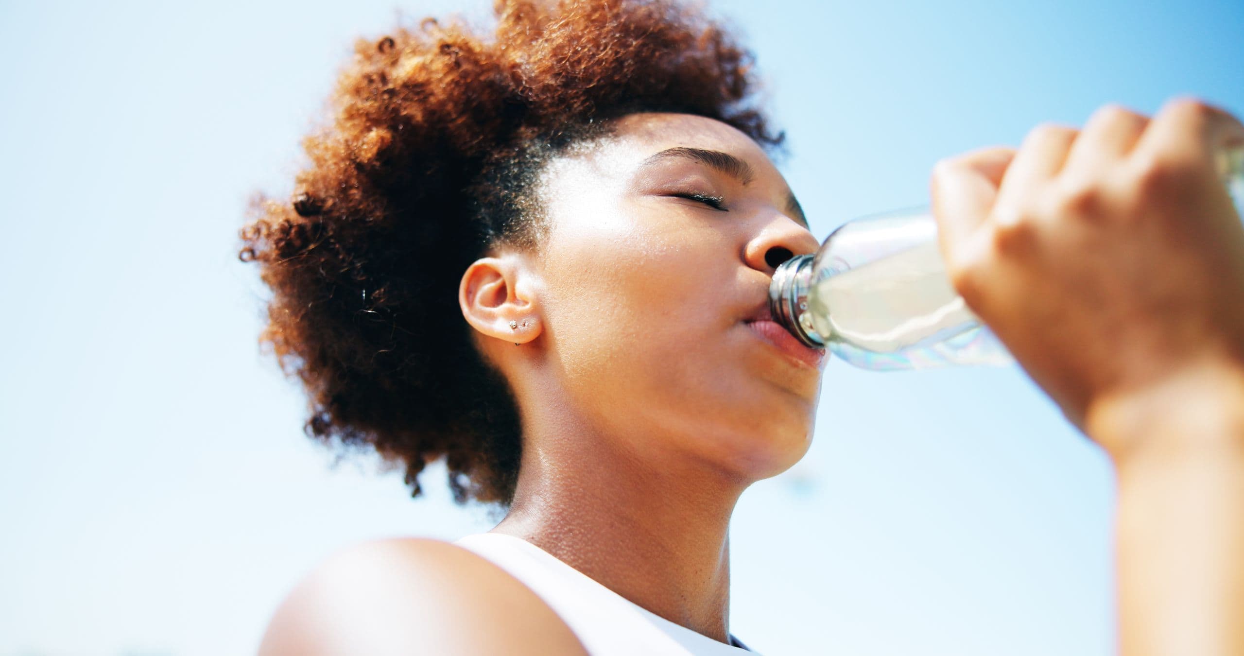 A young lady drinking water after taking her cholera vaccine