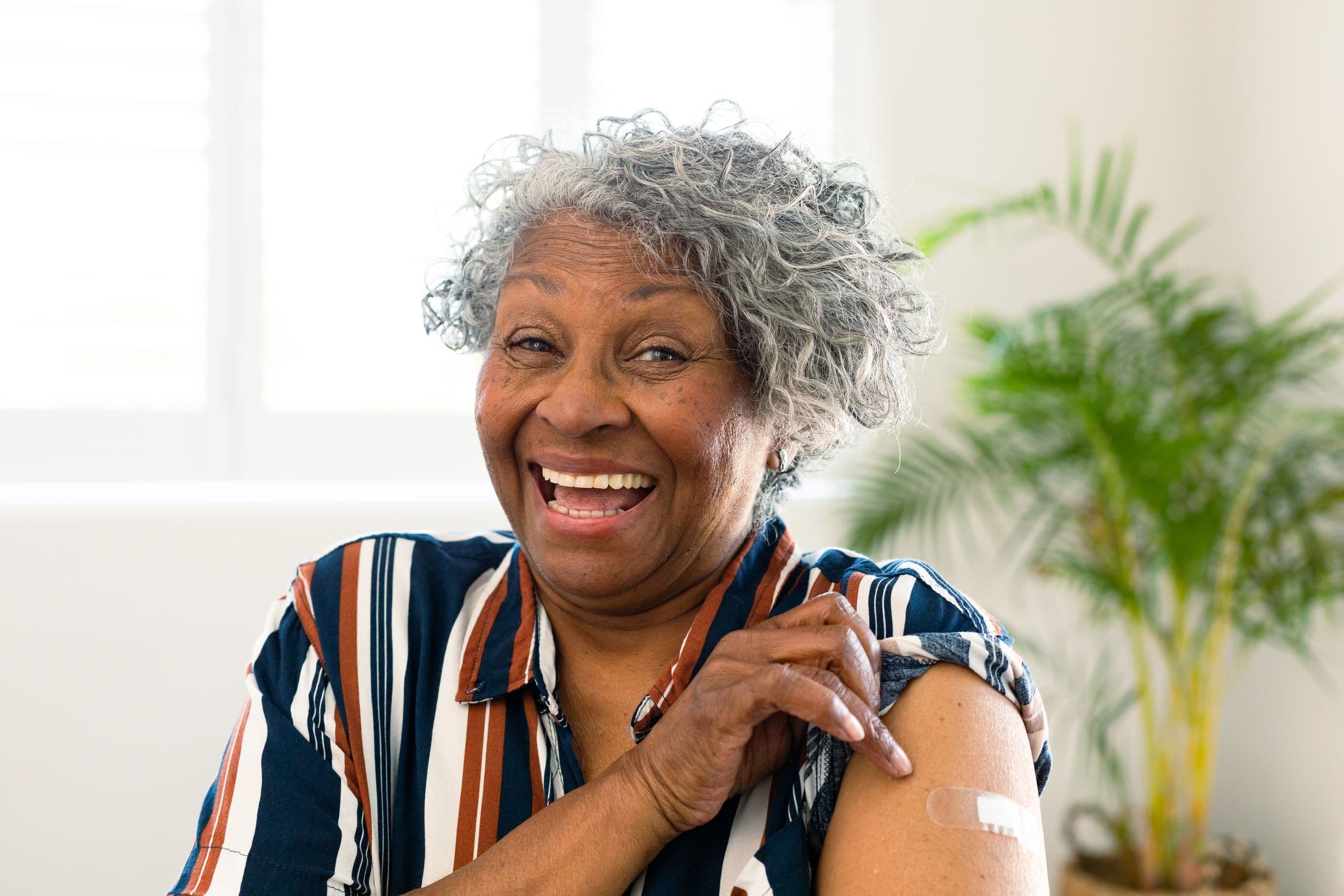 Healthy-older-woman-showing-her-vaccinated-arm