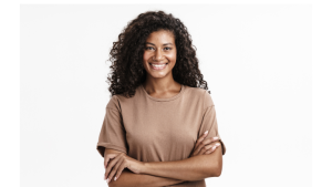 Smiling young woman with curly hair standing confidently, symbolizing empowerment through HPV vaccination awareness.