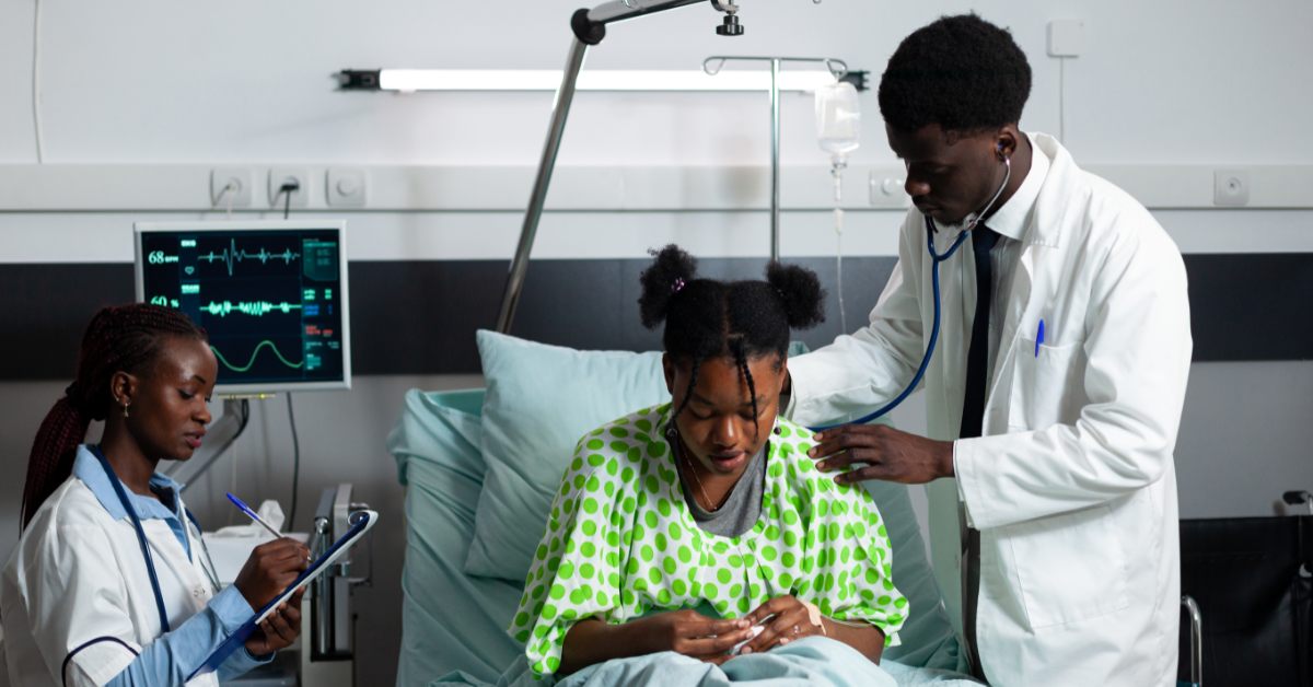 Hepatitis b hepatitis b: A male doctor and female nurse attend to a patient in a Nigerian hospital bed.